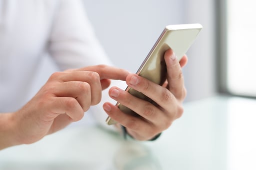 close-up-of-male-hands-using-smartphone-2-1