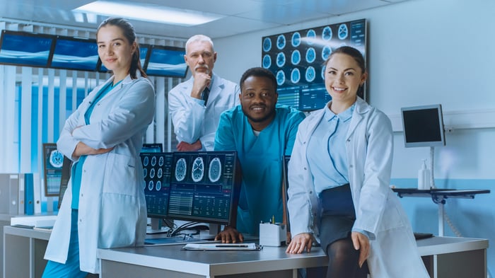 Diverse-Team-of-Medical-Scientist-Posing-with-Crossed-Arms-in-the-High-Tech-Laboratory.-Brain-Sceince--Neurology-Center-Research-Lab-with-Multiple-Dispalys-Showing-CT--MRI-Scan-Images.-1050311782_5120x2880